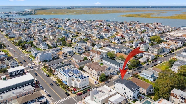 birds eye view of property featuring a water view and a residential view