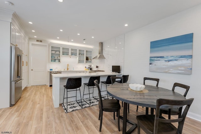 dining space with light wood-type flooring, visible vents, and recessed lighting