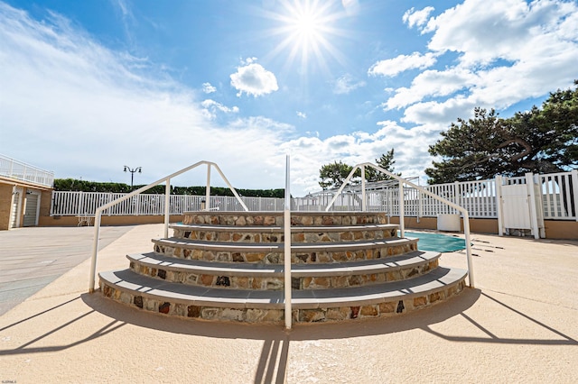 view of swimming pool with fence