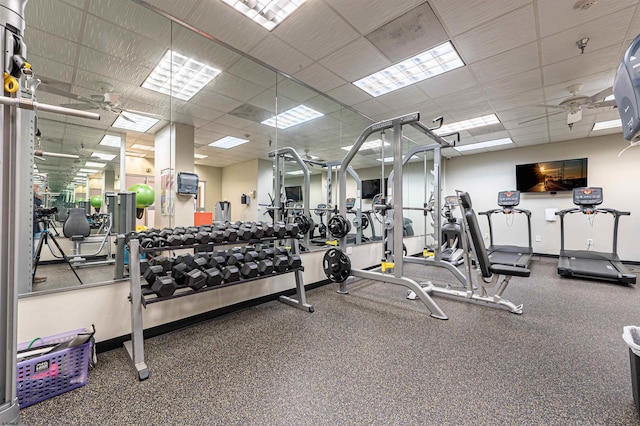 workout area with a drop ceiling and baseboards