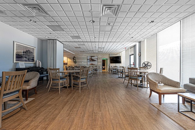 dining area with visible vents and wood finished floors