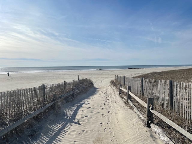 water view with a beach view and fence