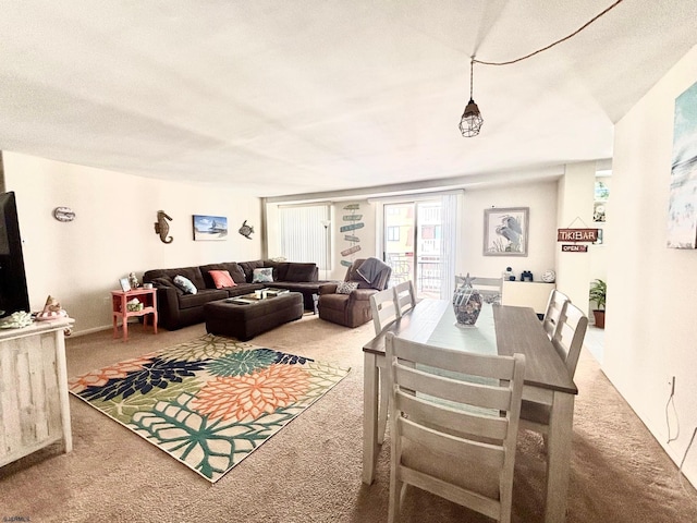 dining area featuring carpet and a textured ceiling