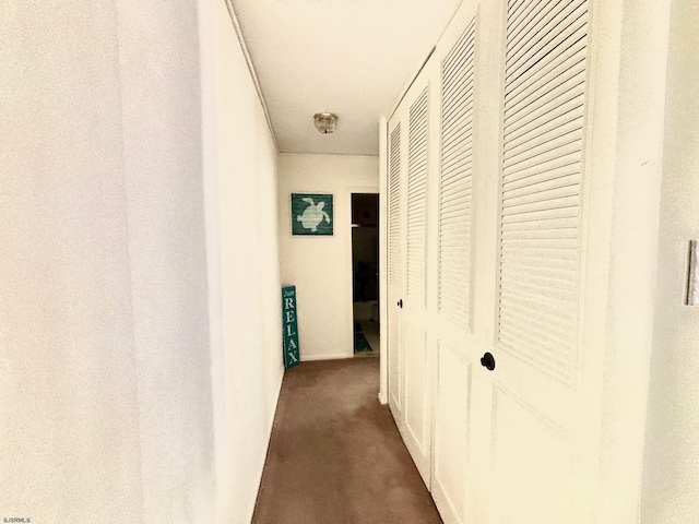 hallway featuring dark colored carpet