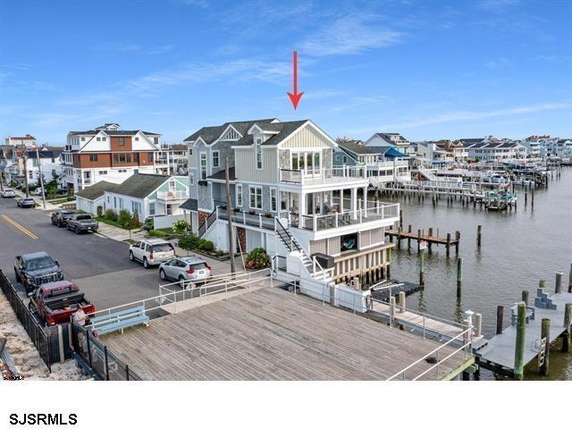 view of dock featuring a water view and a residential view