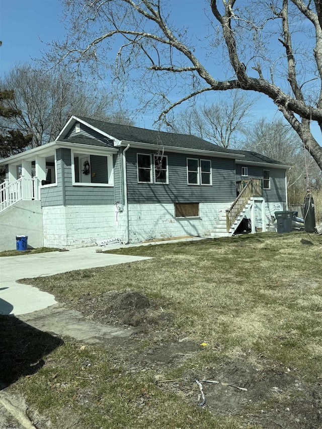 view of front of house featuring a front lawn and stairs