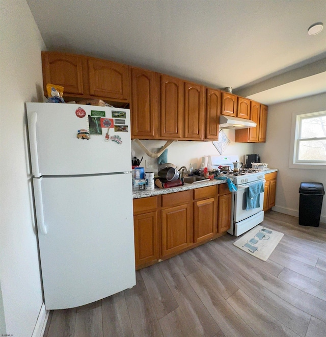 200 E Park Ave, Pleasantville, NJ 08232 - kitchen with white appliances, light wood-style flooring, under cabinet range hood, and brown cabinetry
