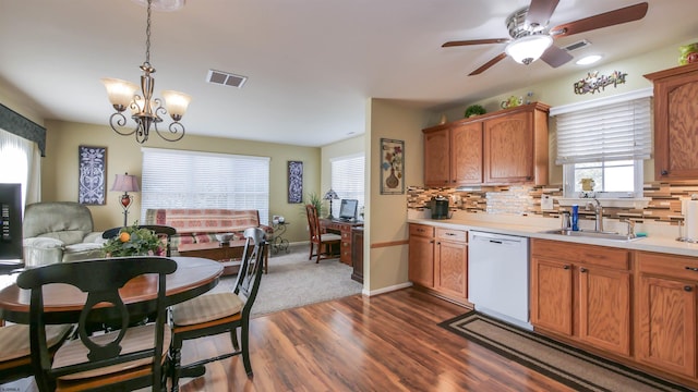 kitchen featuring decorative backsplash, visible vents, dishwasher, and a sink