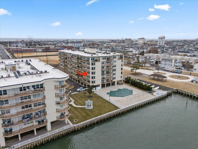 birds eye view of property featuring a water view and a city view