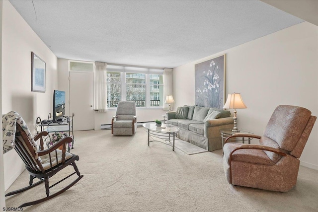 carpeted living room with a baseboard heating unit and a textured ceiling