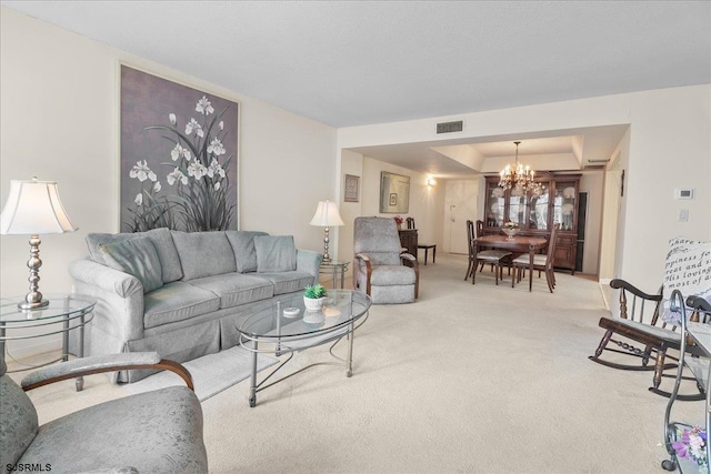 living area with light carpet, an inviting chandelier, visible vents, and a raised ceiling