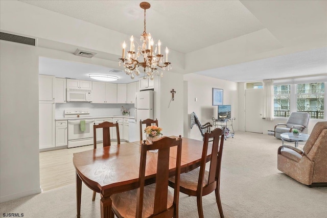 dining space with visible vents and light colored carpet