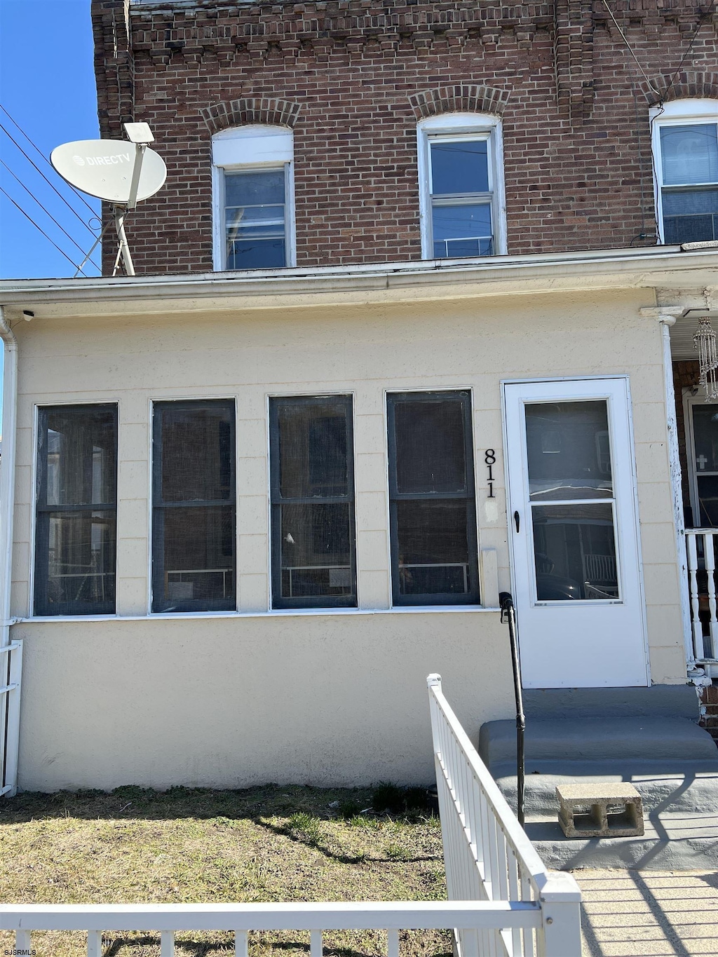 entrance to property featuring brick siding