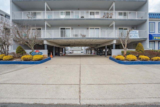 view of property with a carport and driveway