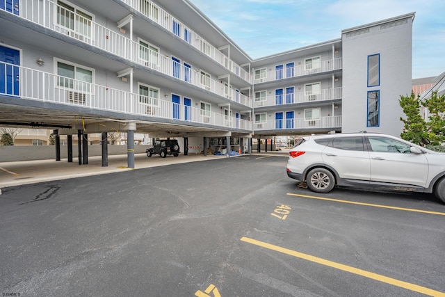 view of building exterior with uncovered parking