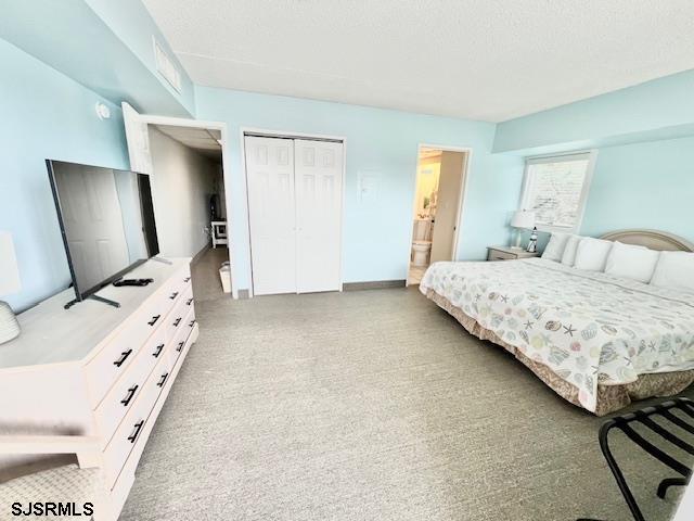 bedroom with a textured ceiling and a closet