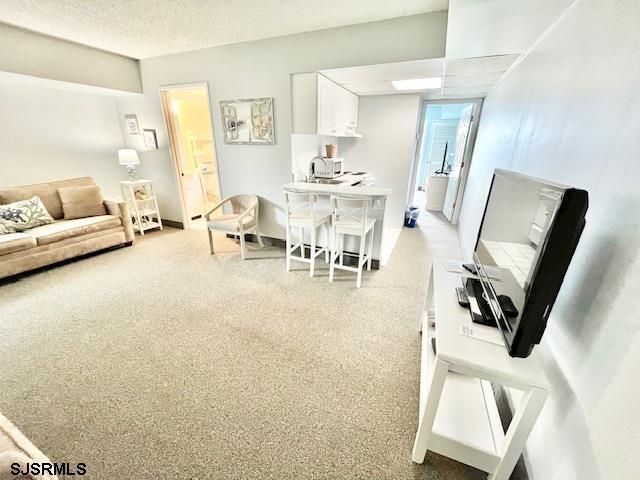 living area featuring a textured ceiling