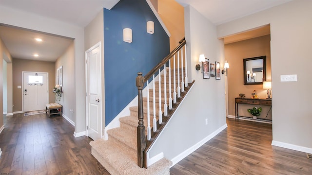 stairs with baseboards and wood finished floors