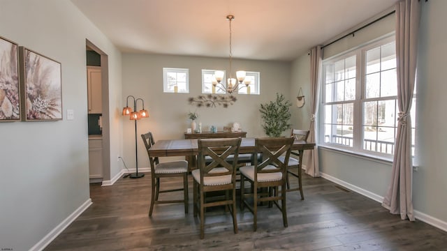 dining room featuring an inviting chandelier, baseboards, and dark wood-type flooring