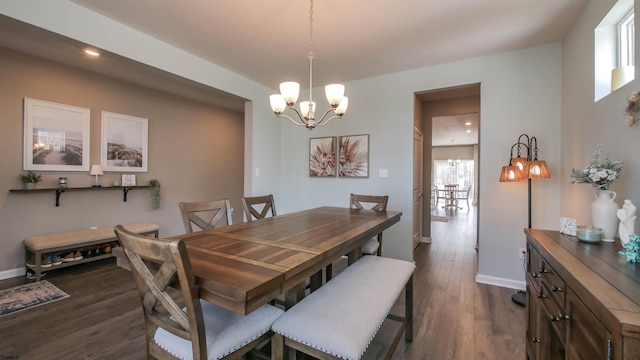 dining area with dark wood-style floors, recessed lighting, baseboards, and an inviting chandelier