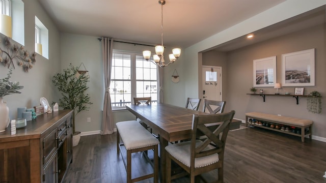 dining space featuring dark wood-type flooring, recessed lighting, a notable chandelier, and baseboards