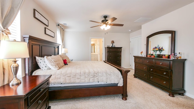 bedroom featuring light carpet, ensuite bath, visible vents, and baseboards