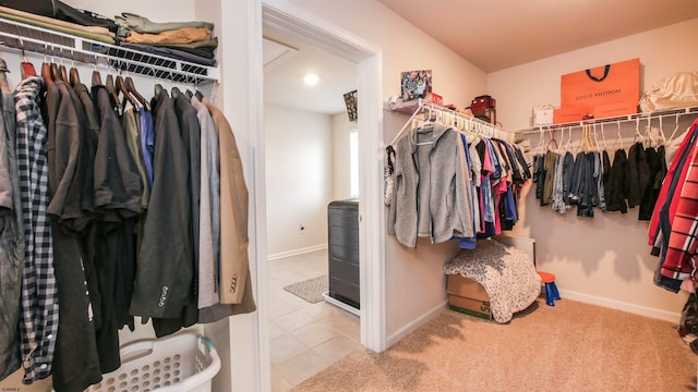 walk in closet with tile patterned flooring and carpet