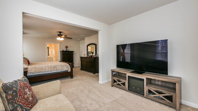 carpeted bedroom featuring baseboards and a ceiling fan