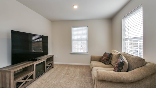 living area featuring carpet floors and baseboards