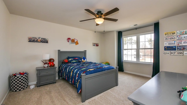 carpeted bedroom featuring baseboards, visible vents, and a ceiling fan