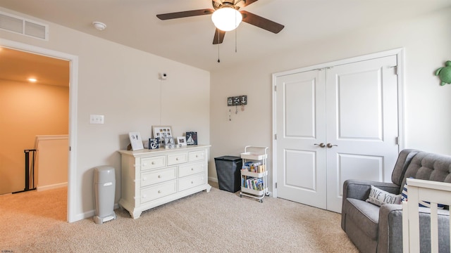 sitting room with light carpet, baseboards, visible vents, and a ceiling fan