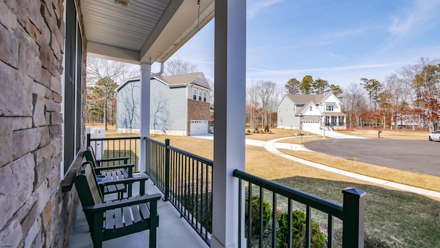 balcony with covered porch and a residential view