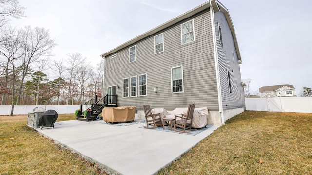 rear view of property with a fenced backyard, a patio, and a lawn