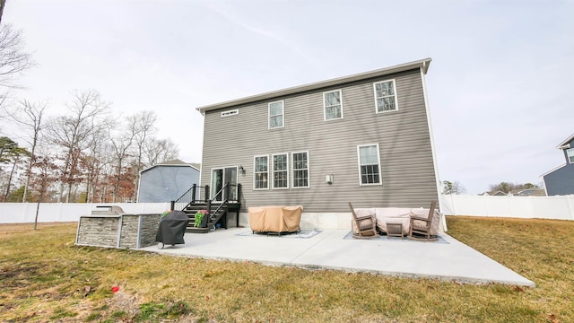 rear view of house with a patio area, a fenced backyard, and a lawn