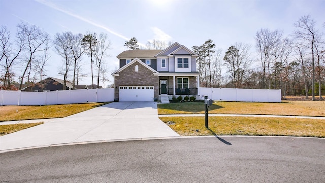 view of front of house with covered porch, driveway, a front lawn, and fence