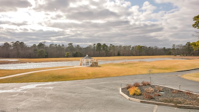 view of road featuring a water view and a wooded view