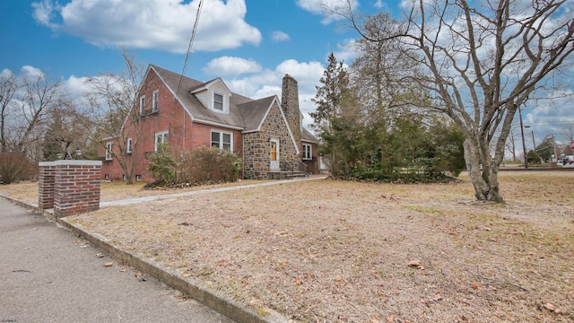 view of property exterior with stone siding and a chimney