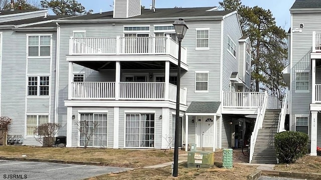 view of front facade with stairway and a chimney