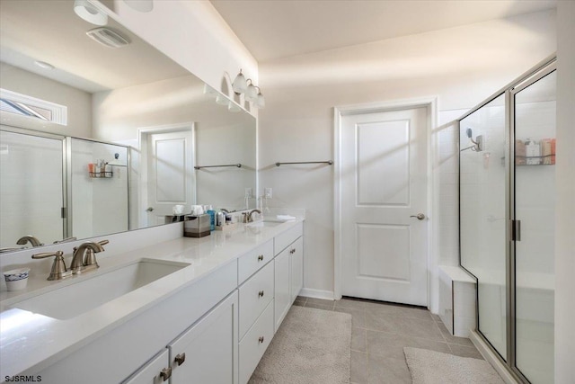 full bath with a shower stall and a sink