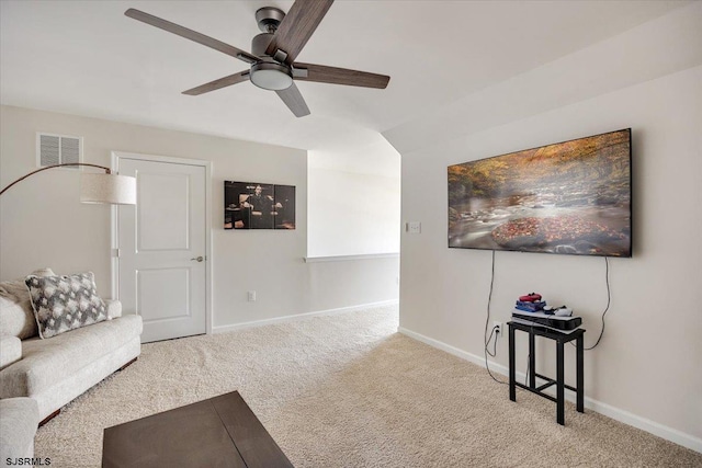 carpeted living room featuring ceiling fan, visible vents, and baseboards