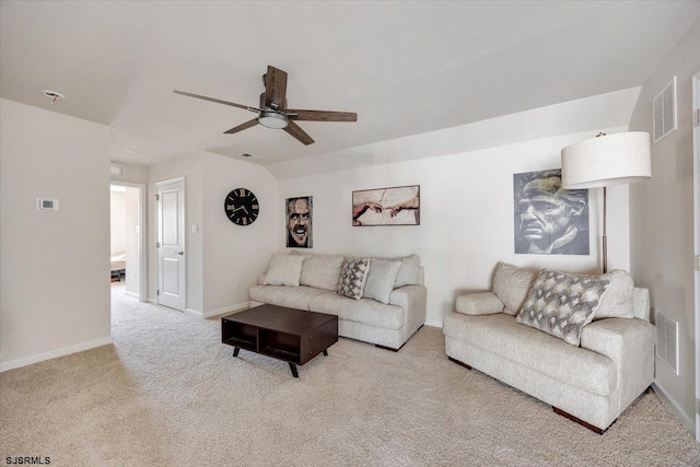 living area featuring visible vents, baseboards, ceiling fan, and carpet flooring