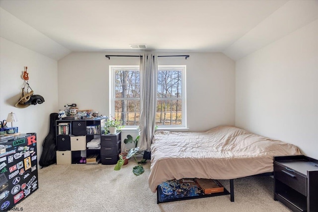 bedroom featuring carpet floors, visible vents, and vaulted ceiling