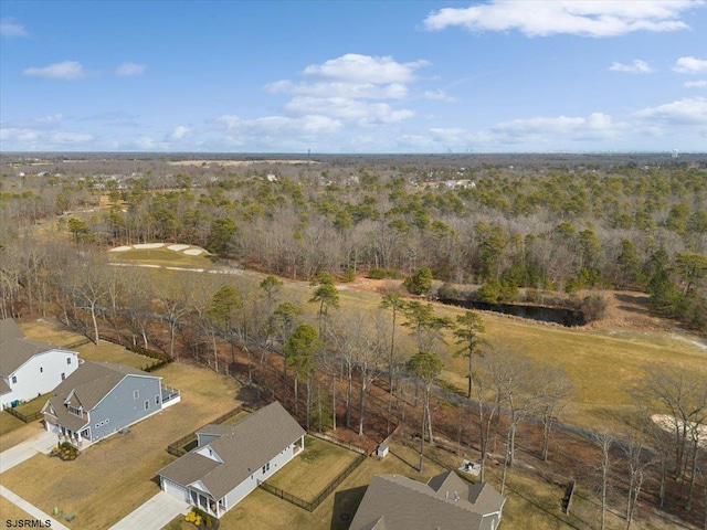 birds eye view of property with a wooded view