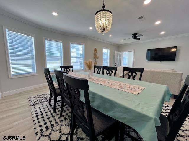 dining room with visible vents, baseboards, light wood-style flooring, ornamental molding, and recessed lighting