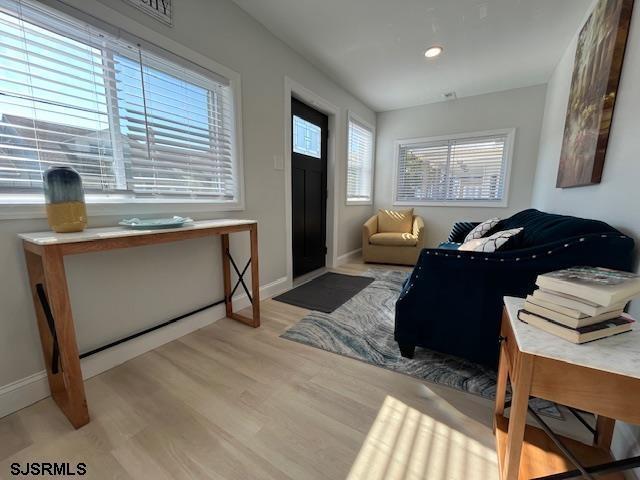 foyer featuring recessed lighting, baseboards, and wood finished floors