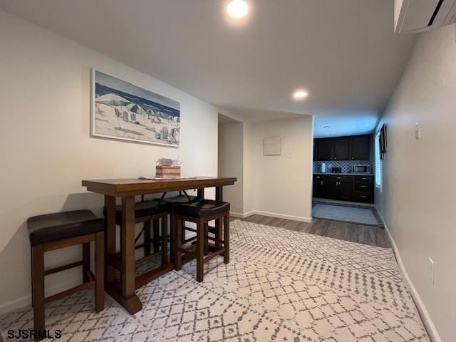 dining room with light wood-type flooring and baseboards