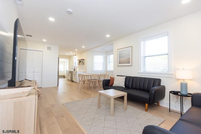 living area featuring recessed lighting, visible vents, and light wood-style floors