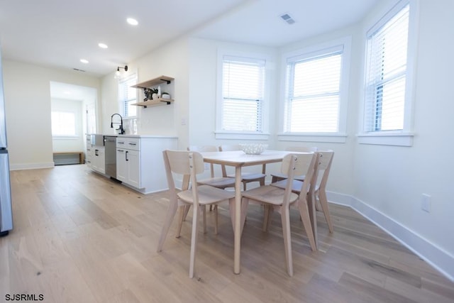 dining space featuring light wood-type flooring, visible vents, baseboards, and recessed lighting