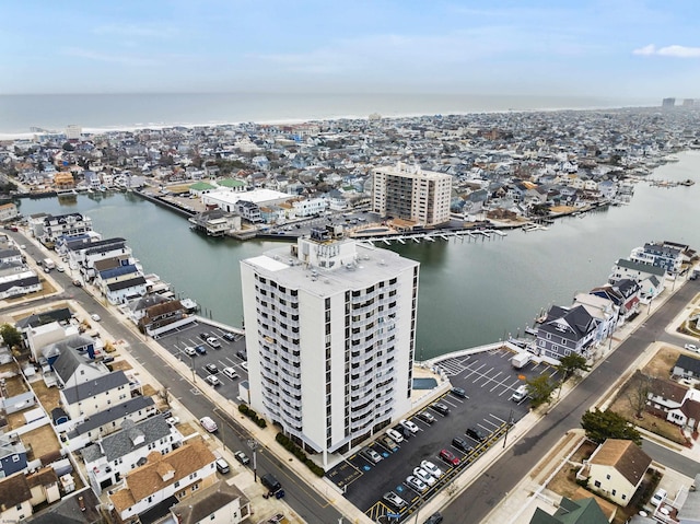 drone / aerial view featuring a view of city and a water view