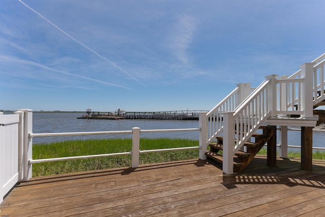 wooden terrace featuring a water view